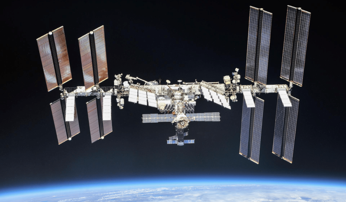 International Space Station orbiting Earth with solar panels extended before NASA's planned 2030 retirement and deorbi