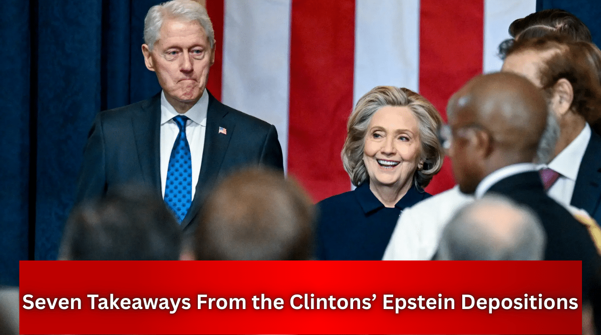Bill Clinton and Hillary Clinton standing at a public event with an American flag backdrop