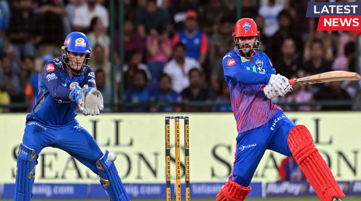 Delhi Capitals batsman plays a powerful shot while Mumbai Indians wicketkeeper prepares behind the stumps during IPL match
