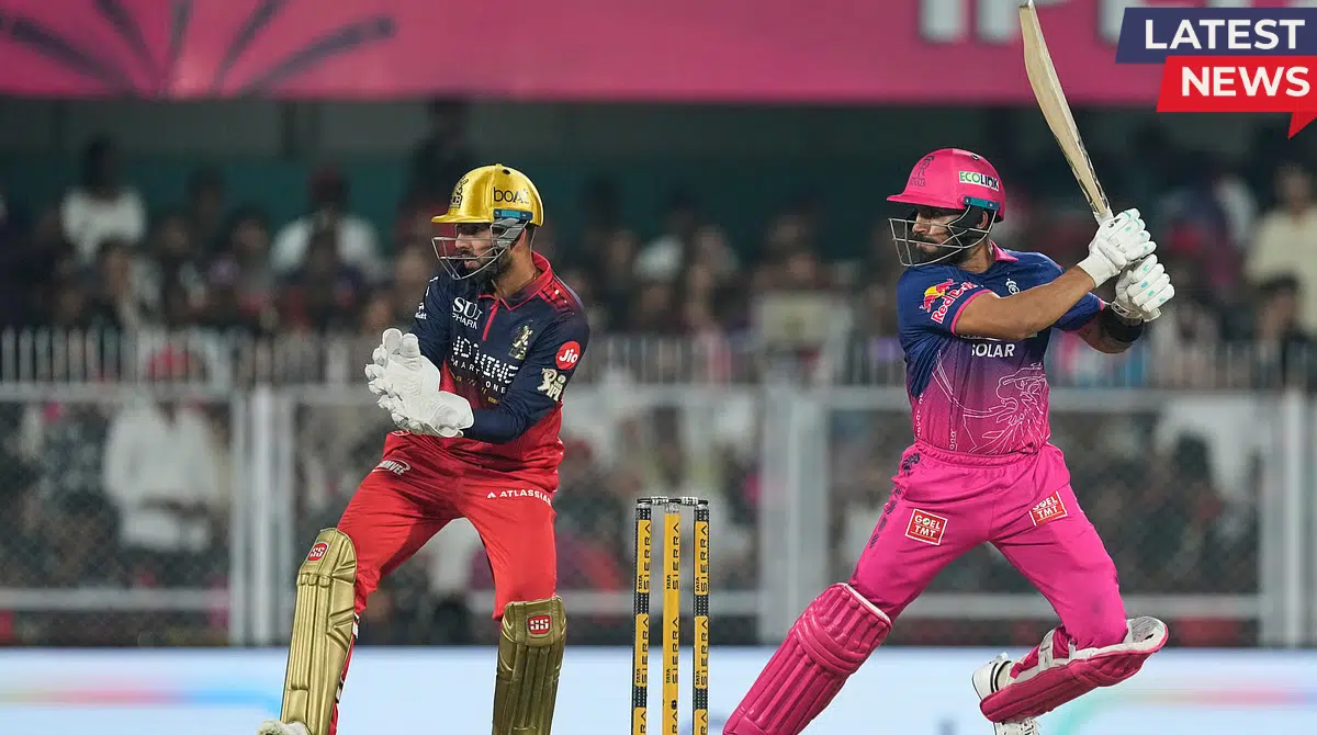 Rajasthan Royals batter playing a shot while RCB wicketkeeper prepares behind the stumps in IPL 2026 match