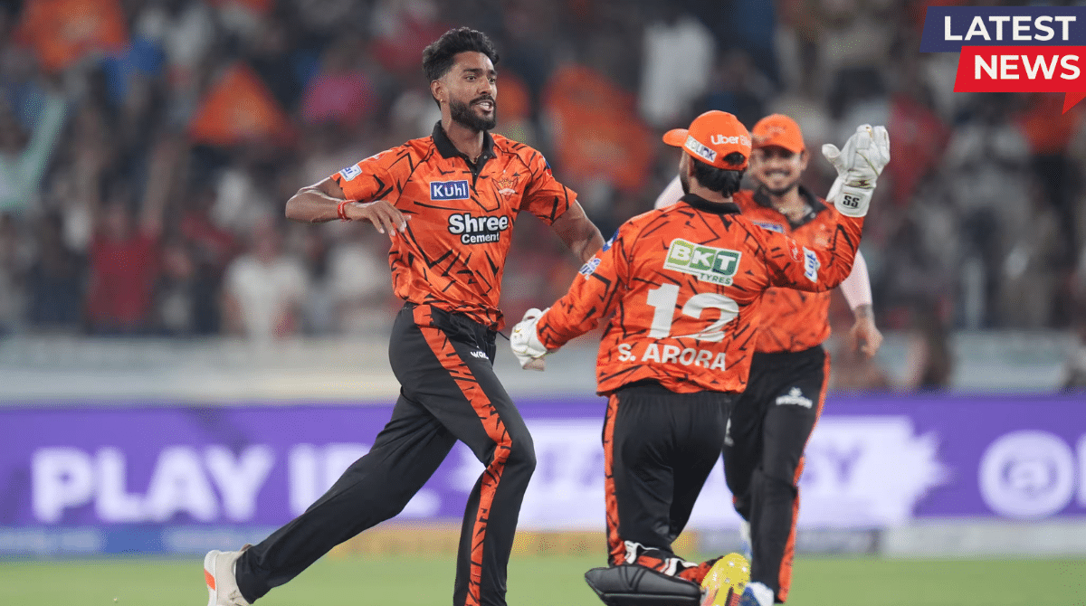 Sunrisers Hyderabad players in their vibrant orange and black patterned jerseys celebrating a wicket on the field during an IPL 2026 match against Rajasthan Royals.